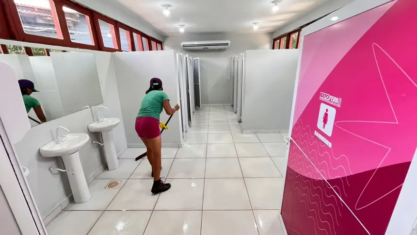 Calaboradora realiza a limpeza e desinfecção dos banheiros
